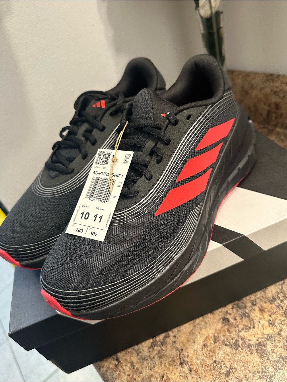 adidas black and red running shoes on box